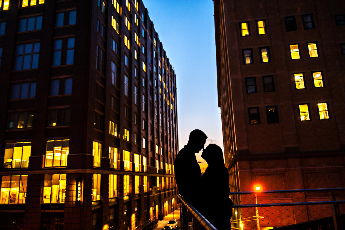 A NYC silhouette cityscape on an engaged couple.