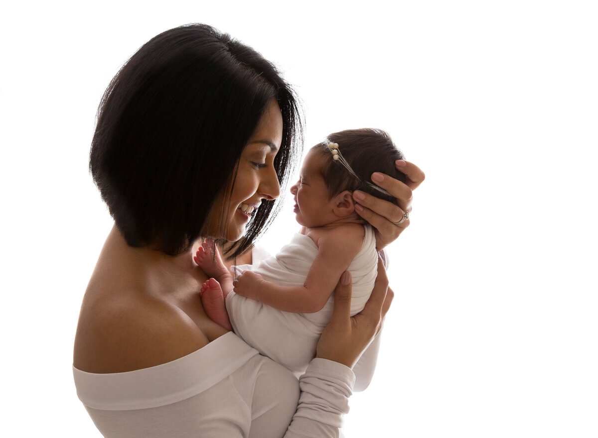 Loving mother cradling her newborn baby, captured in an intimate NYC newborn photography session