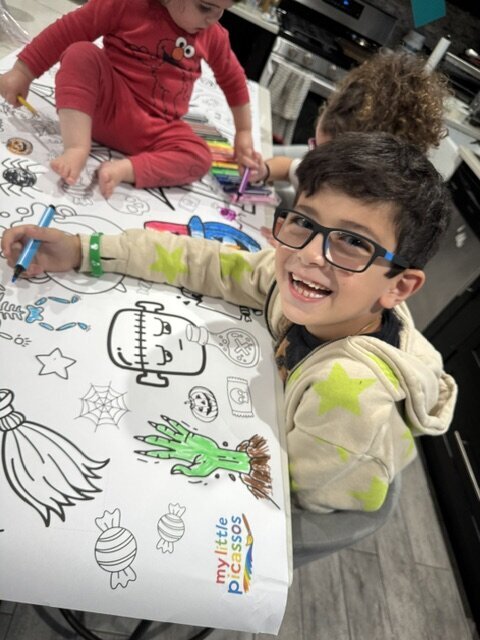 little boy smiling coloring halloween banner 2