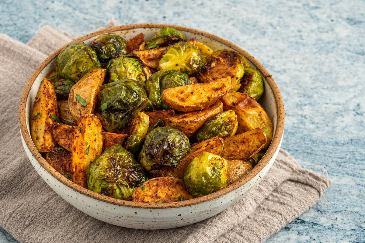 roasted potatoes and brussels sprouts hero shot for Eating Well