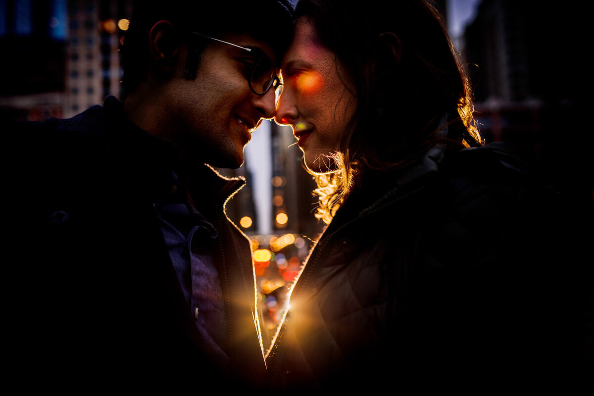 A couple hugs in a ray of light during a Millennium Park engagement session.