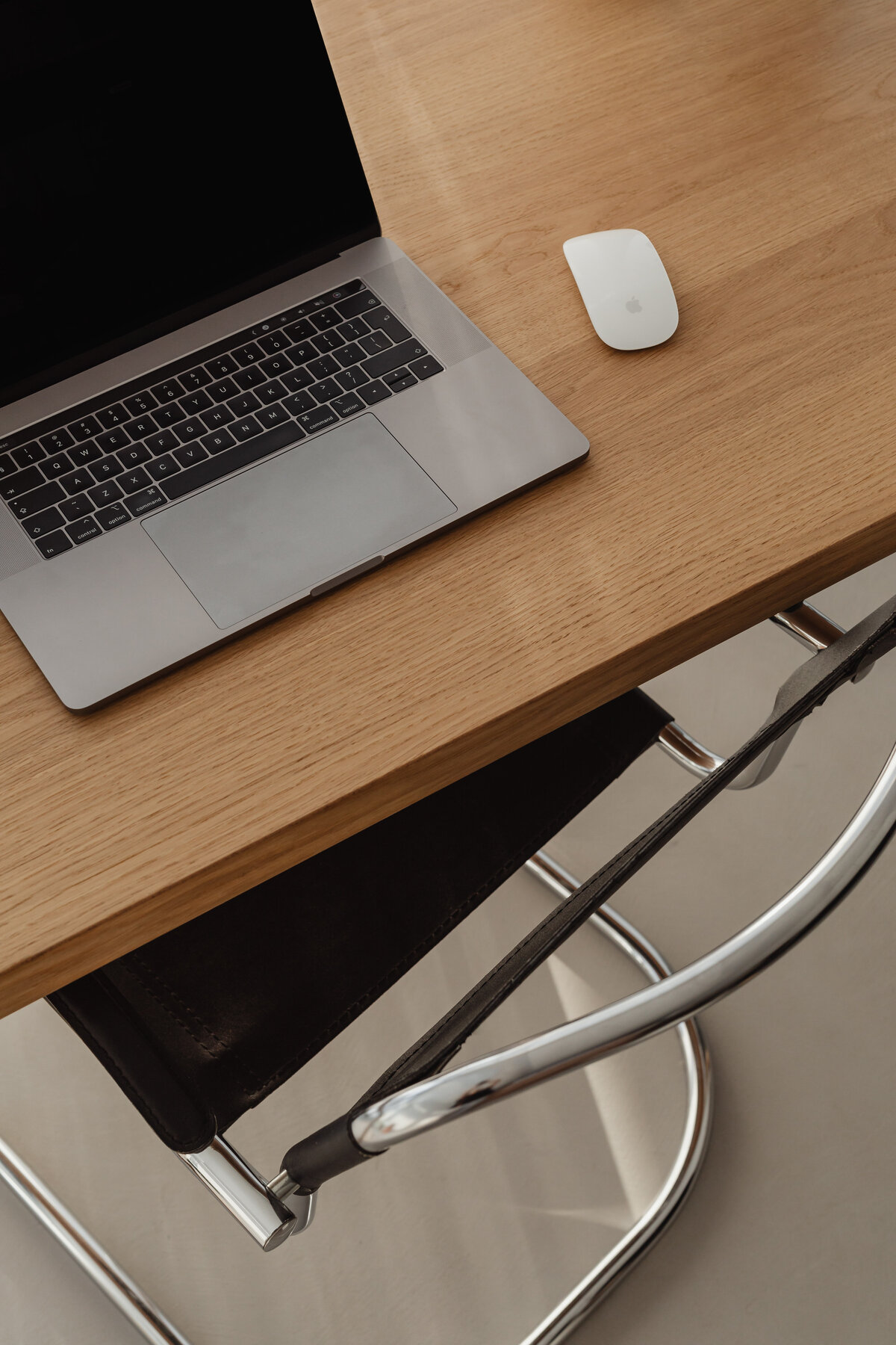 Warm workspace: laptop, candle, travertine lamp, shelves
