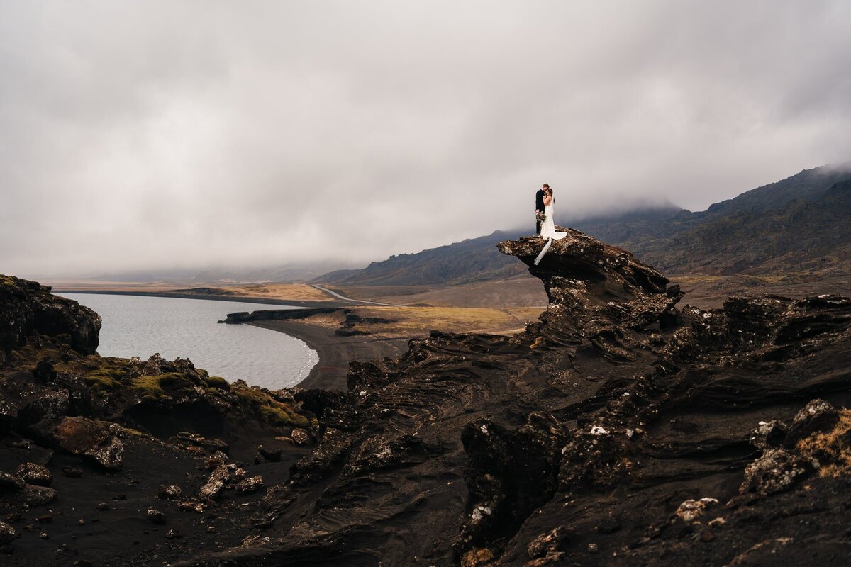Behold this epic landscape featuring the couple, sharing a magical moment during their Iceland elopement. Nature's grandeur beautifully frames their love story.