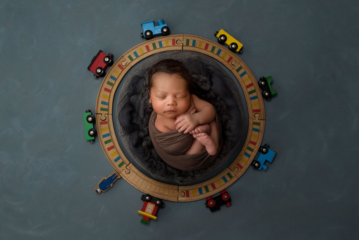 baby boy newborn photo session with trains. 
