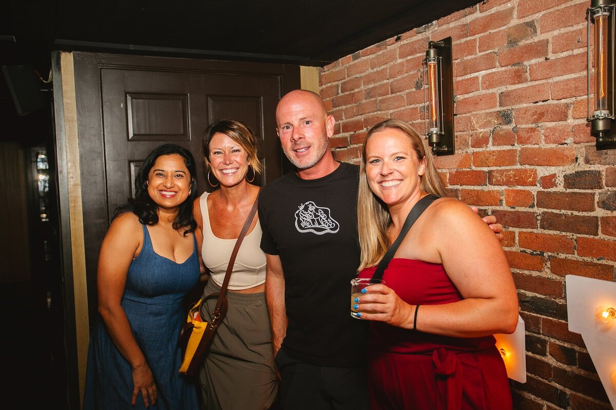 a-group-of-young-business-professionals-smiling-and-posing-at-a-networking-event-in-indianapolis-dressed-in-business-casual-attire