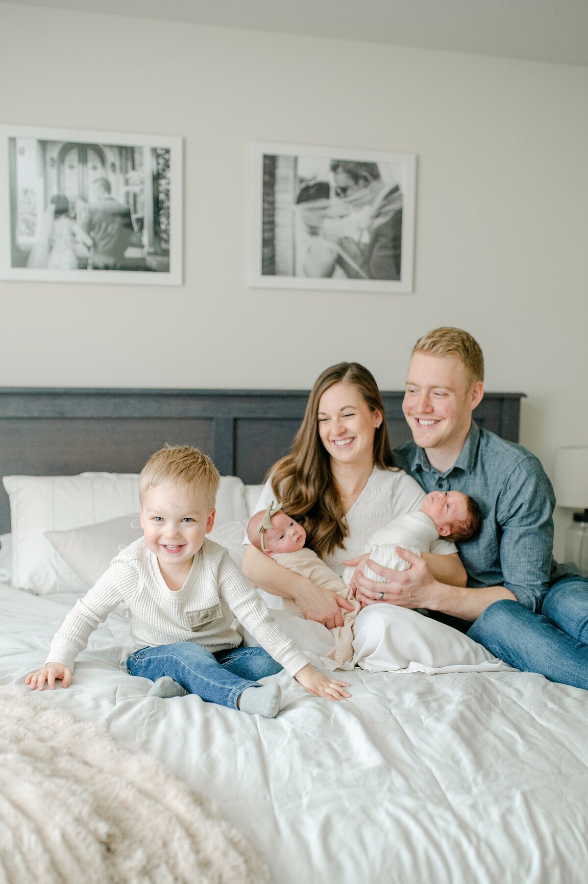 Family playing on bed at milwaukee newborn session