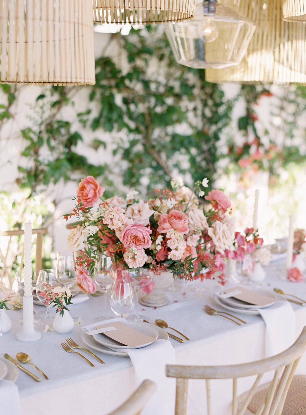 Table details with flower arrangements photographed during a luxury wedding at Montecito Club in Santa Barbara by Wedding Photographers Pinnel Photography
