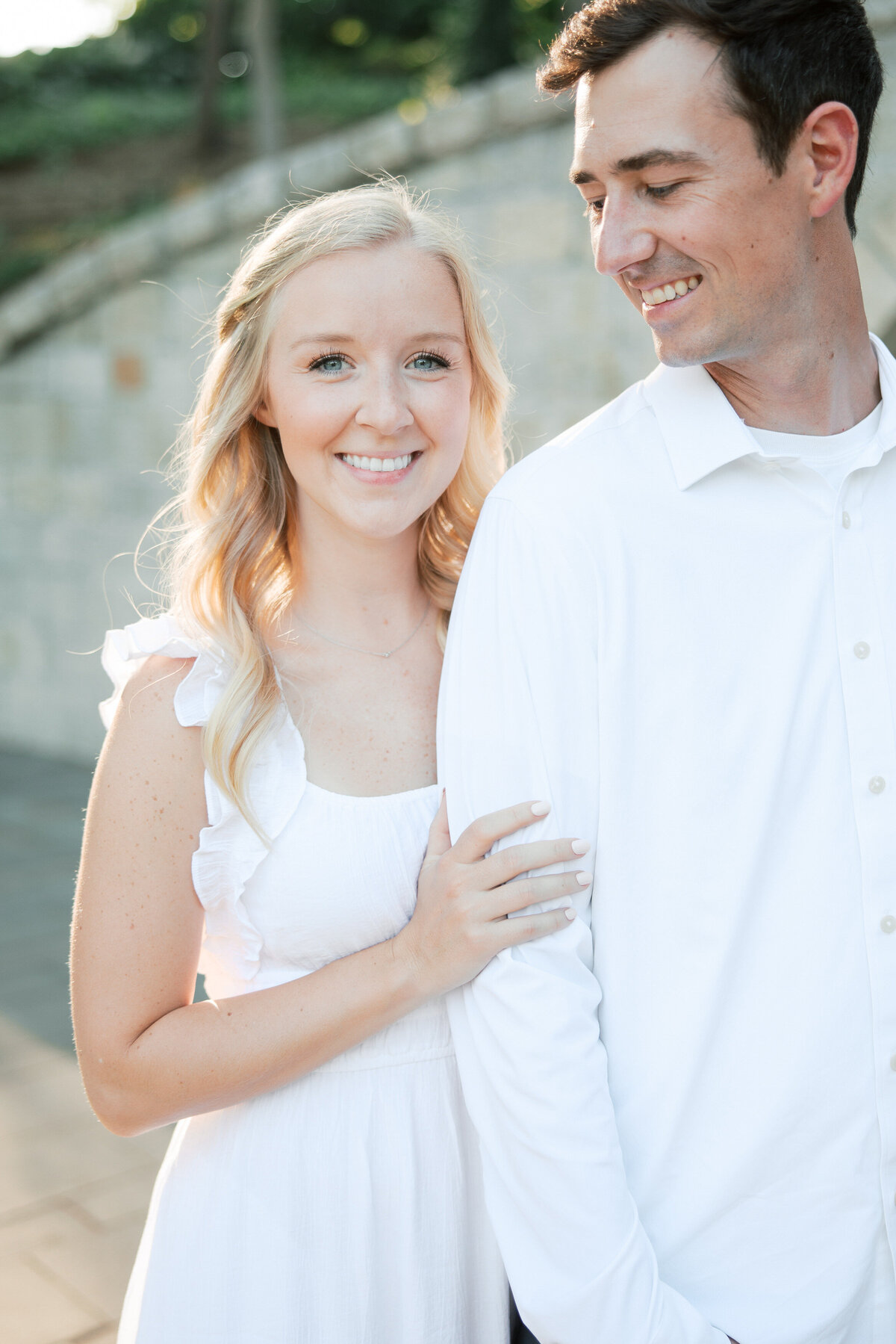 Bride-to-be hugs fiancé during Ohio engagement session, taken by Philadelphia wedding photographer.