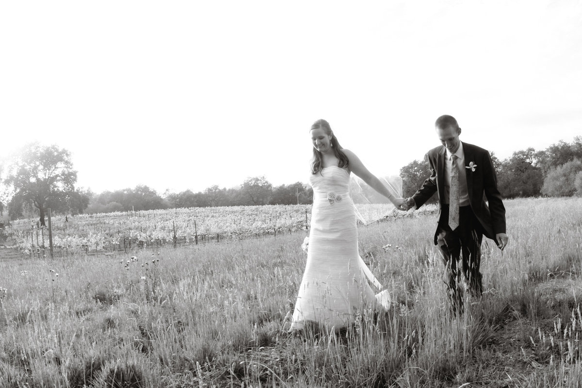 black and white of couple walking in field