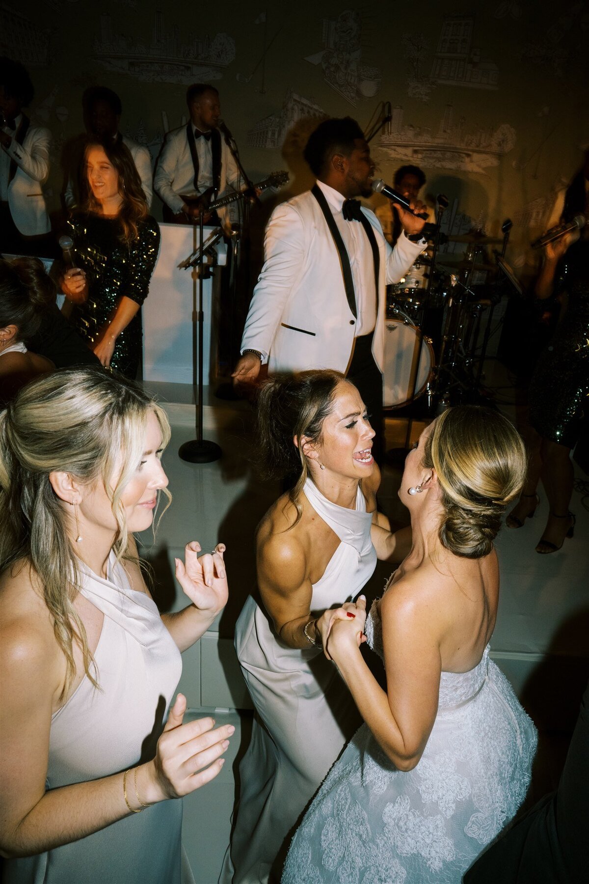 Close up of the bride dancing with the bridesmaids. 