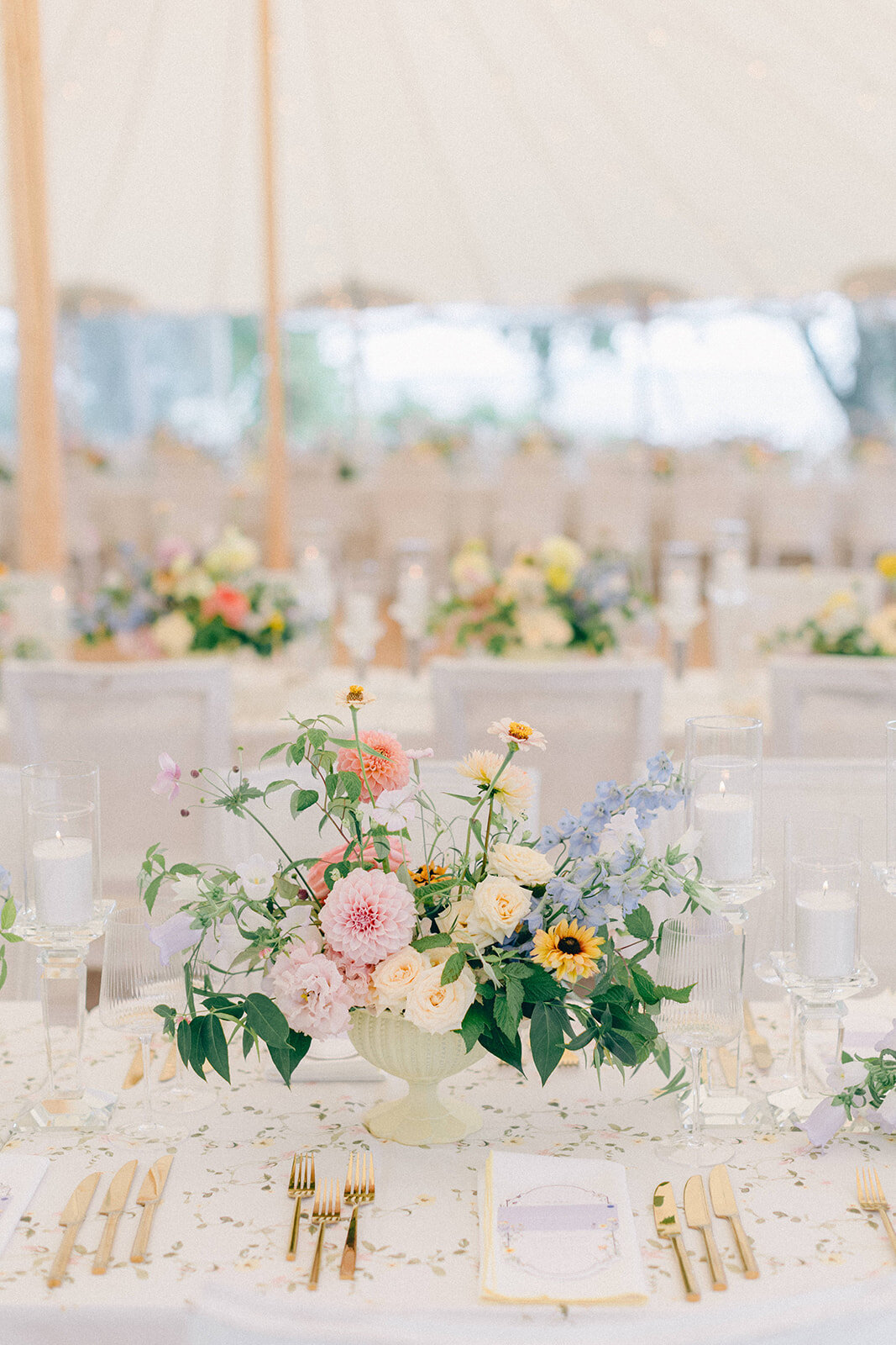 Pastel, garden flowers in an organic centrepiece at a Forest and Stream Club wedding reception.
