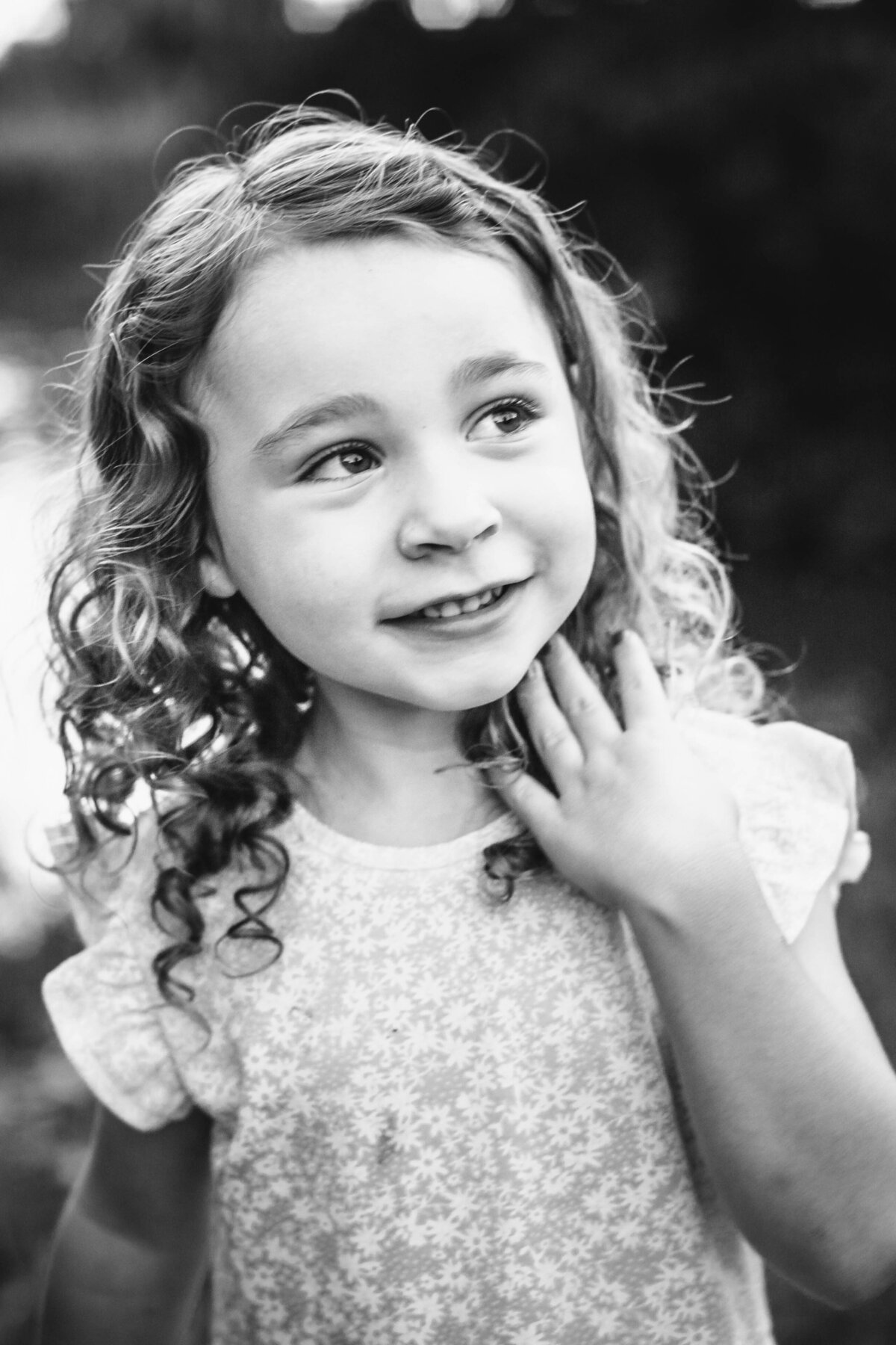 portrait of a girl in black and white gazing up with amazing curly hair