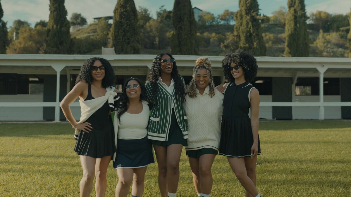 A group of women laughing on a bowling green.