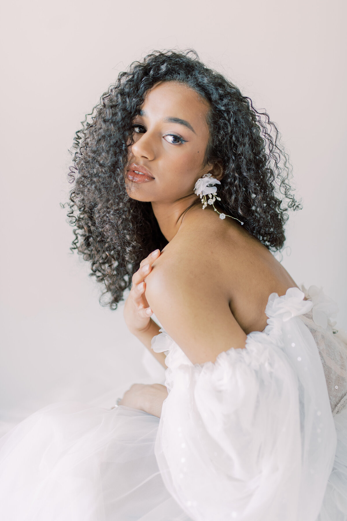 Bride holding her chest , side profile with her curly hair in toronto