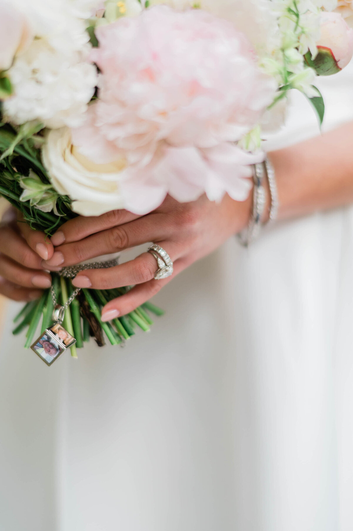 A close-up of the bride’s bouquet, featuring delicate white and blush flowers