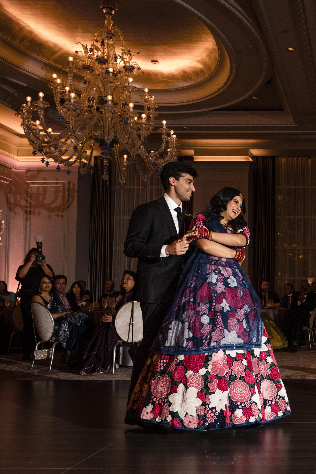 Indian wedding reception at the Grand Bohemian Hotel Charlotte with bride and groom sharing their first dance, photographed by a top Indian wedding photographer in Charlotte.
