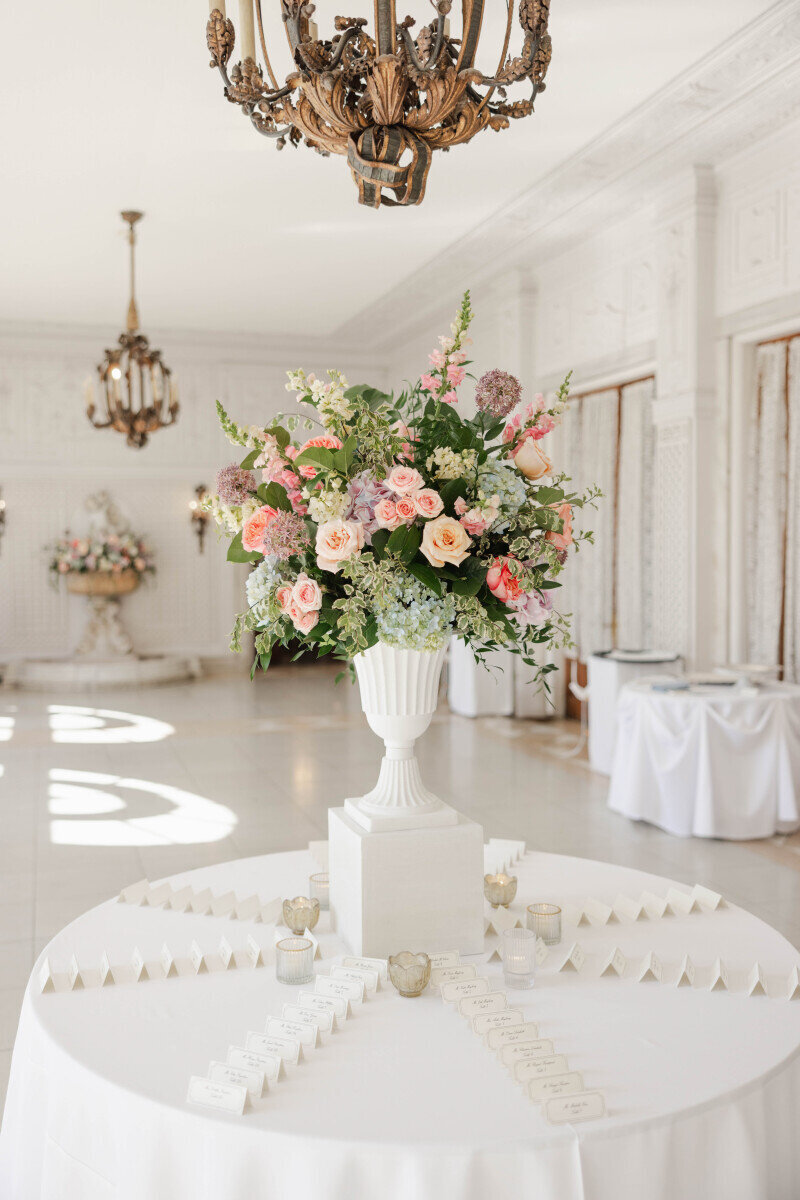 summer wedding place card table florals in urn