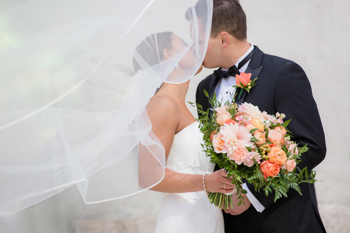 Bride and groom kiss under her veil at the Ohio Statehouse 