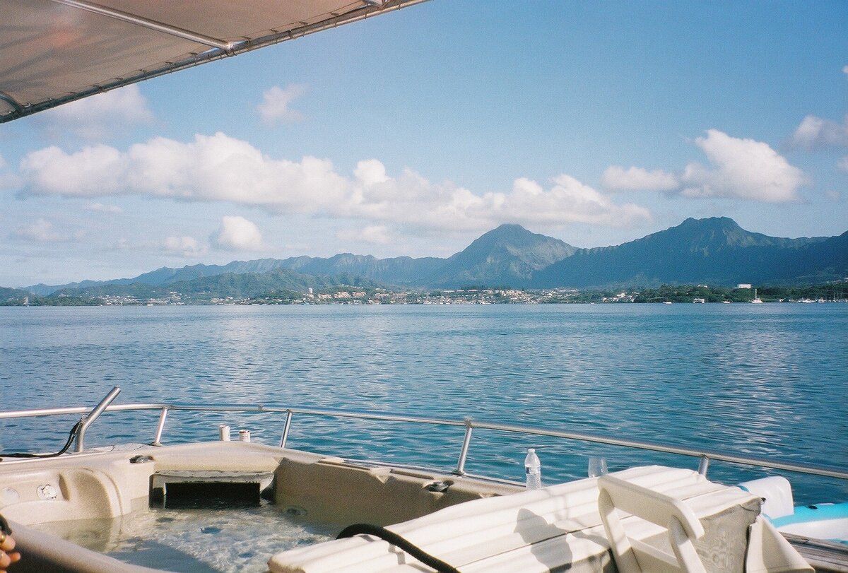 Yacht hot tub on the ocean in Hawaii captured on film by Kate Winters Photography, showcasing a luxurious and relaxing moment in an authentic, documentary style.