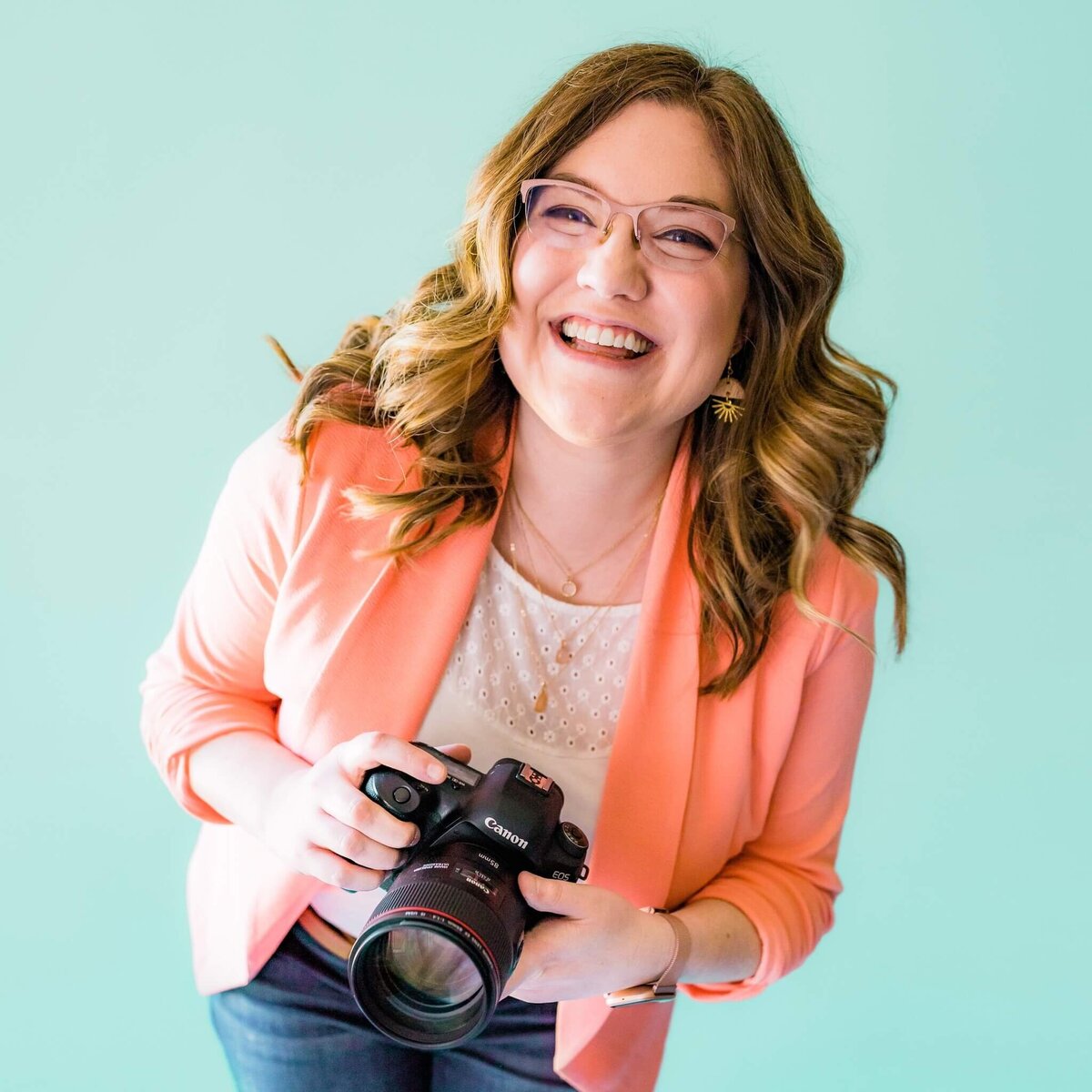 Brand Shoot for Photographer holding camera with blue background