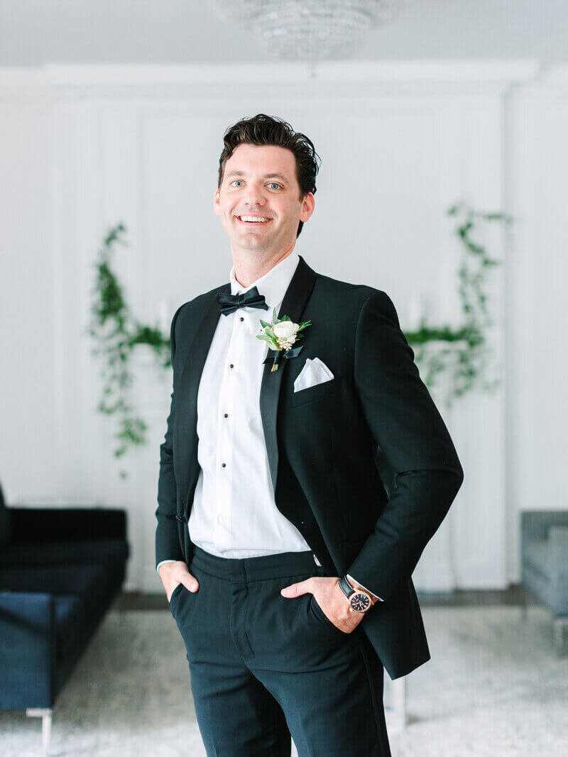 Groom with hands in pockets by chicago wedding planners