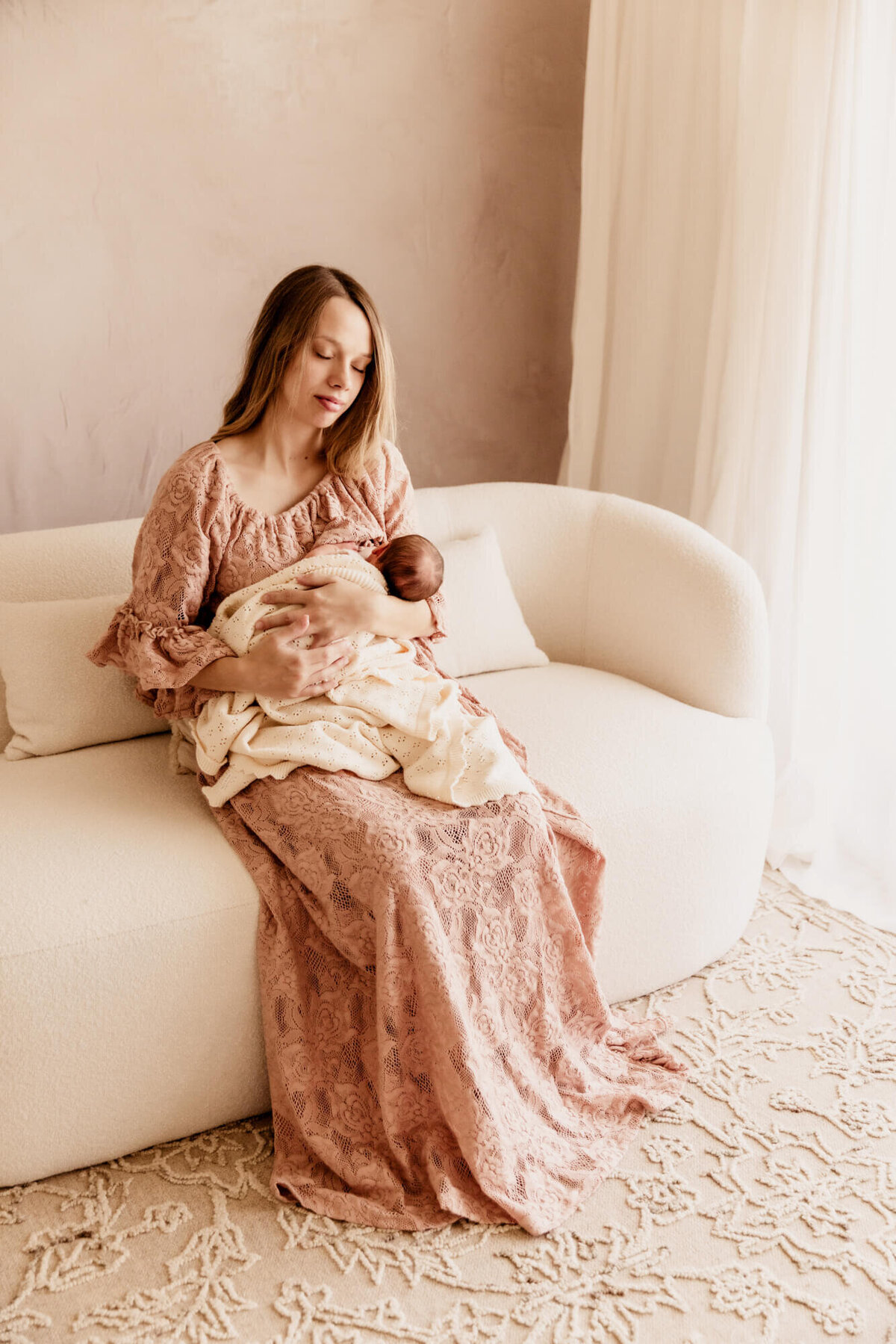 Mother breastfeeding her newborn baby girl for a photo session in Yukon, Oklahoma.