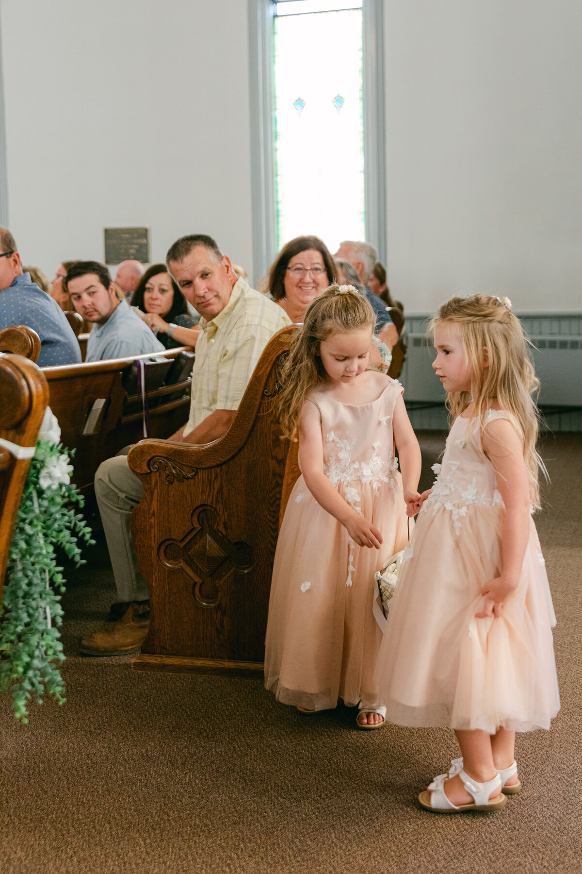 flower-girls-before-ceremony-church-aisle