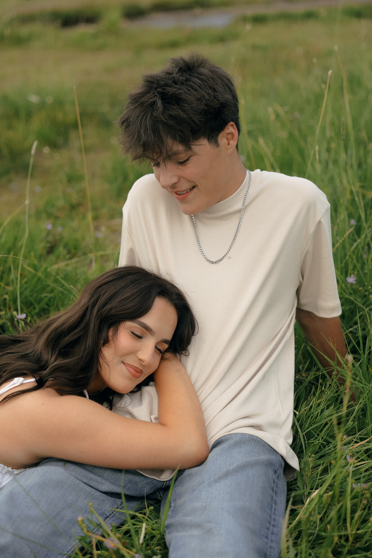 Peaceful Couples Portrait Relaxing in Wildflower Field at Sunset