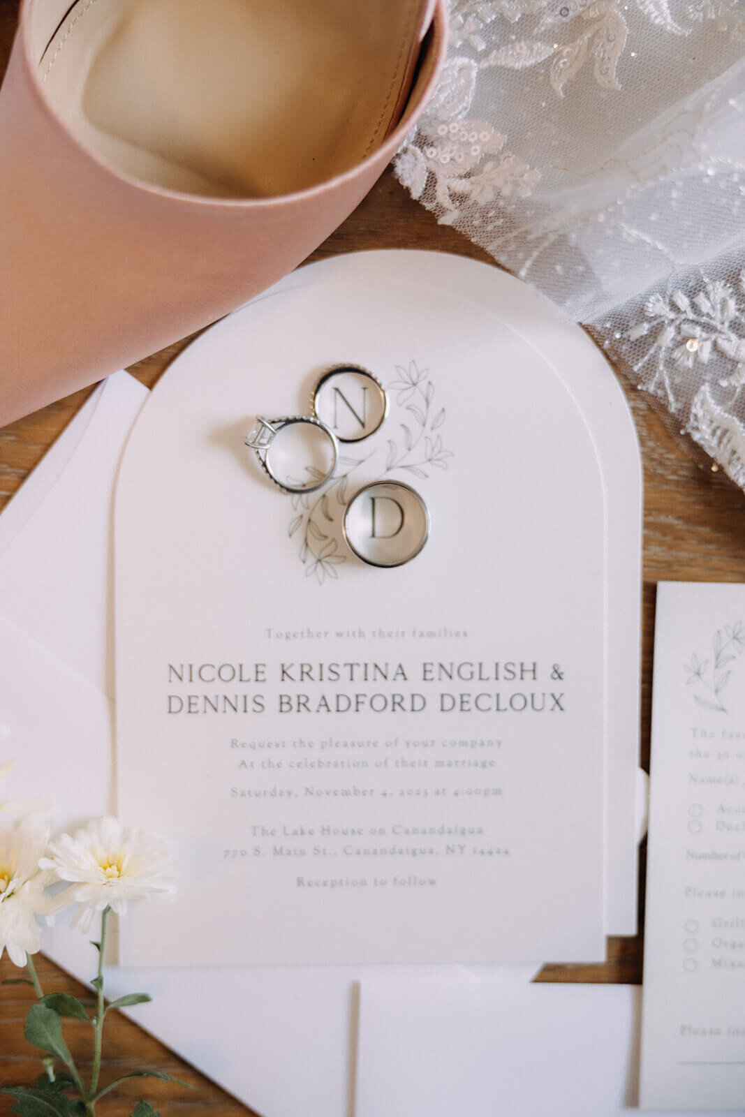 Flatlay of wedding invitations and rings for wedding at The Lake House on Canandaigua