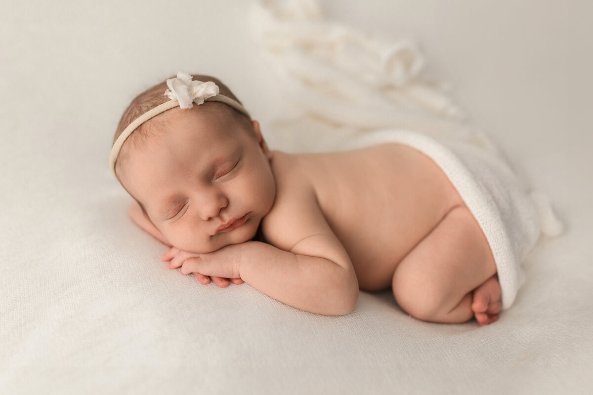 Baby girl on white backdrop