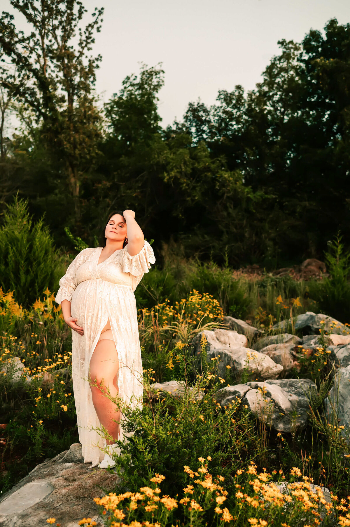 maternity photo in Joplin MO of pregnant mom in yellow flowers