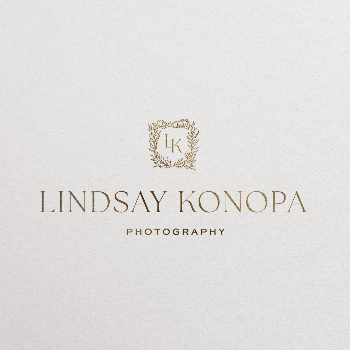 a mockup showing a photographer logo in gold foil