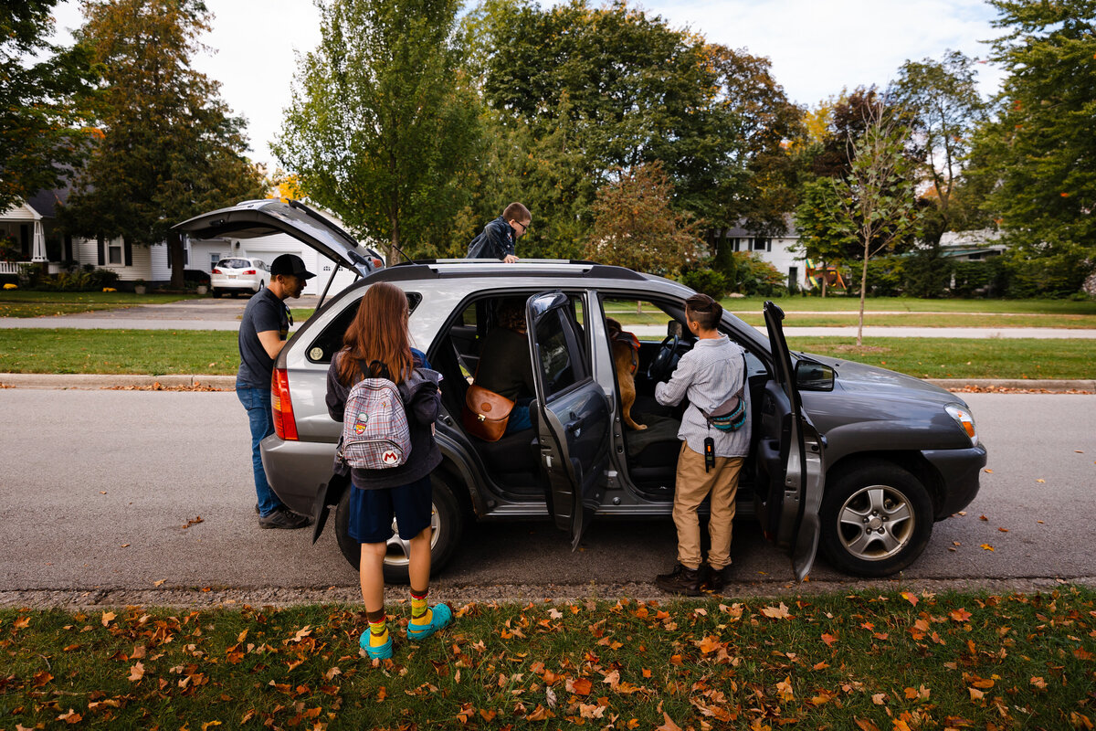 family-getting-in-car