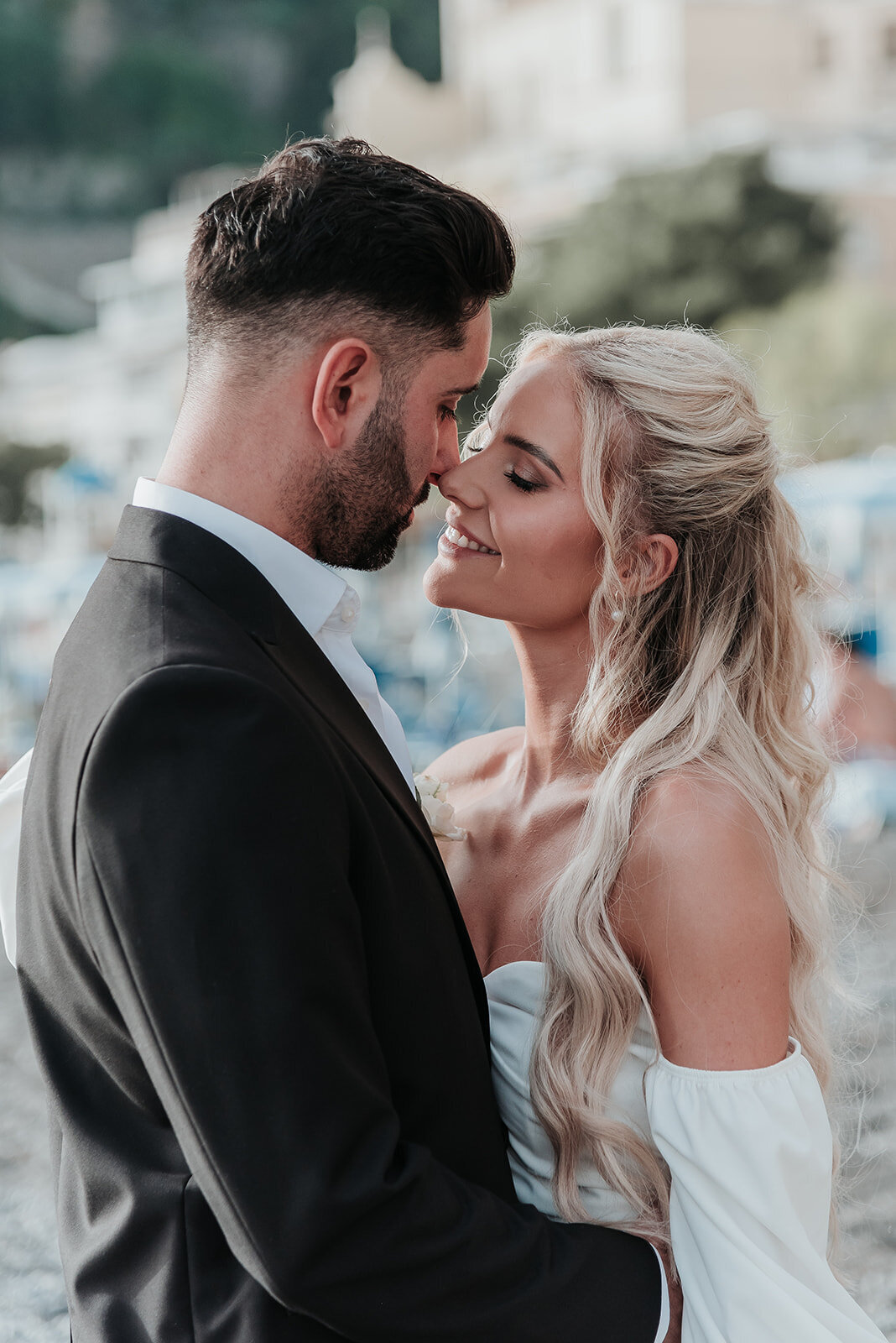 Close up of Bride and Groom leaning in for a kiss during their boat ride in Positano 
