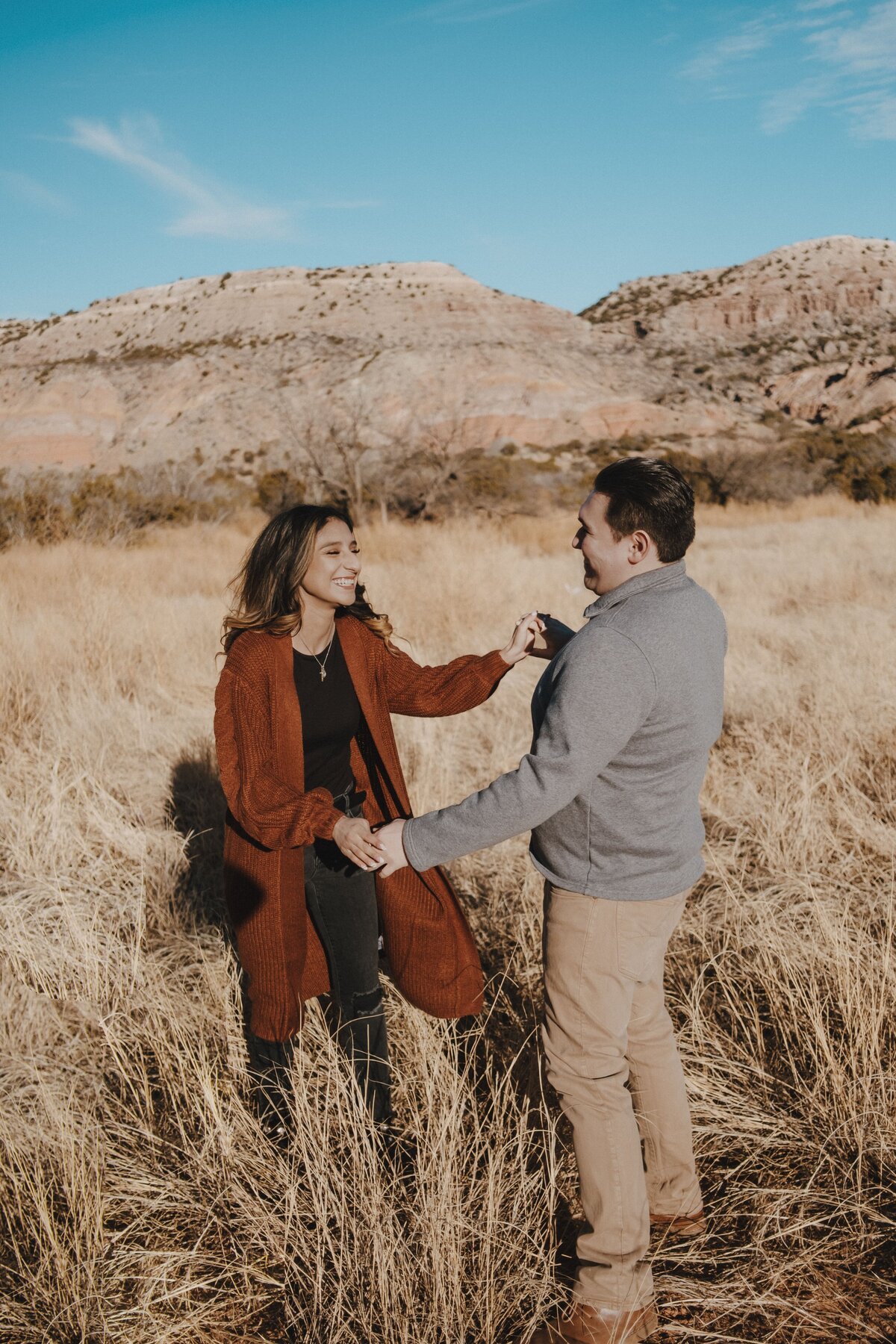 Engaged couple enjoying their adventure engagement session at Palo Duro Canyon in Canyon, Texas