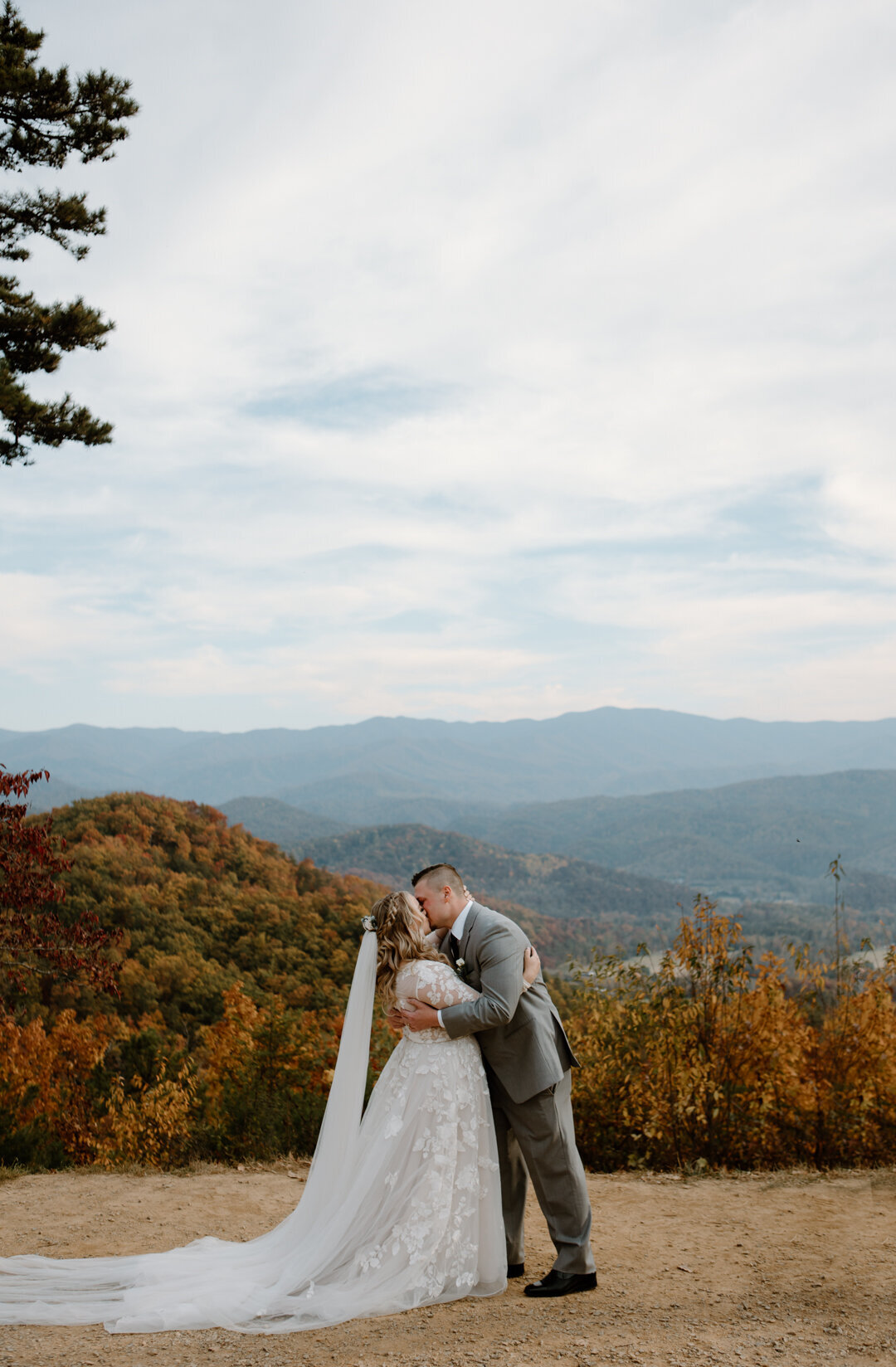 Bride and groom first kiss at their mountain overlook elopement.