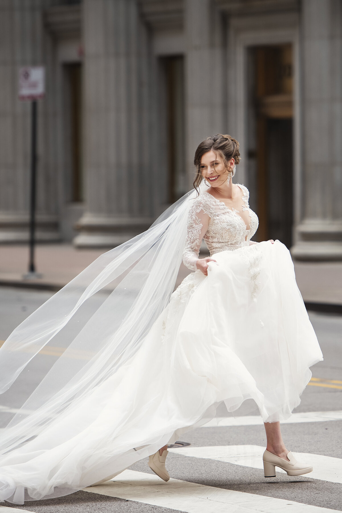 Bride in white wedding dress crossing the street in Chicago