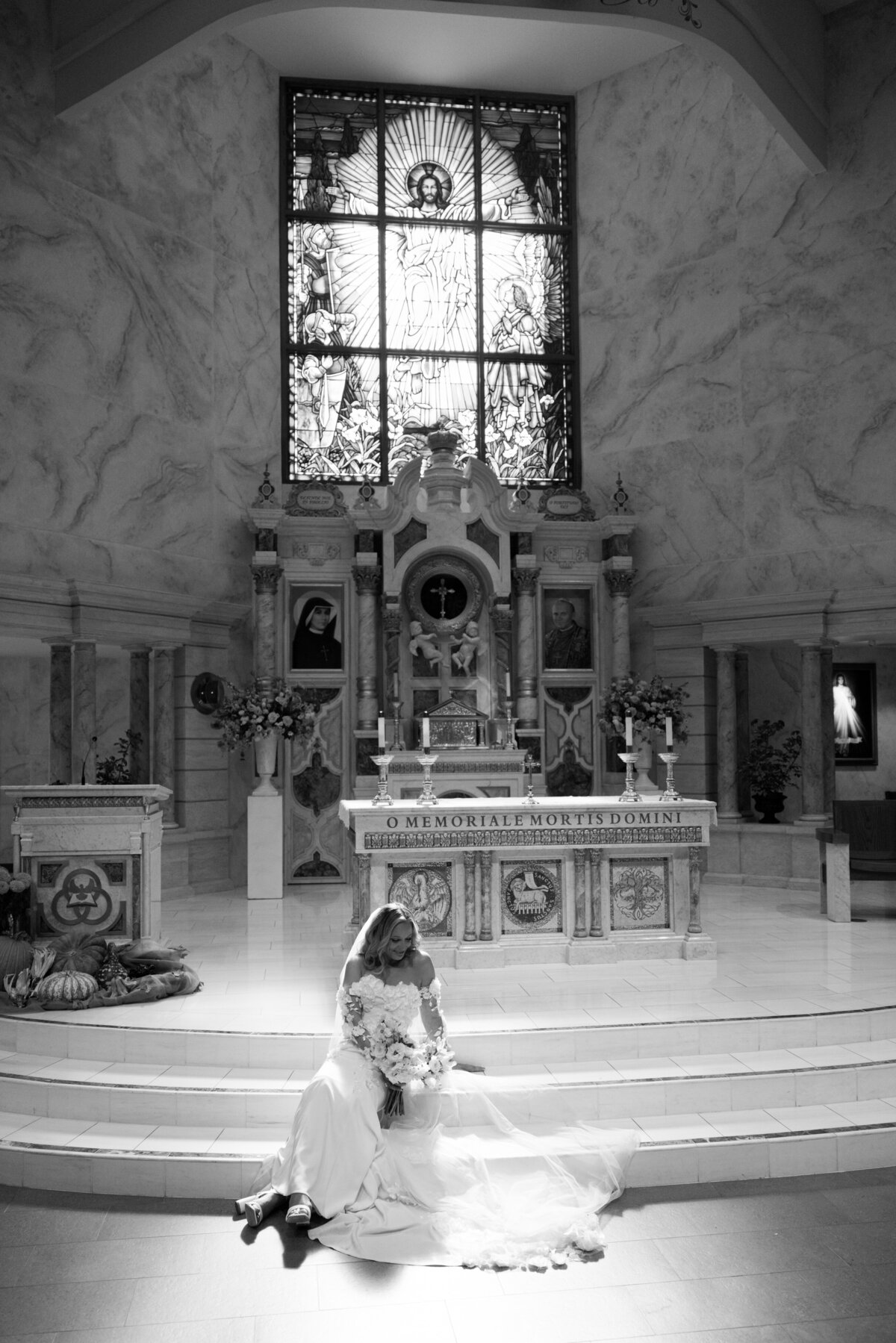 Bride sitting on steps of alter at a church in Southern California