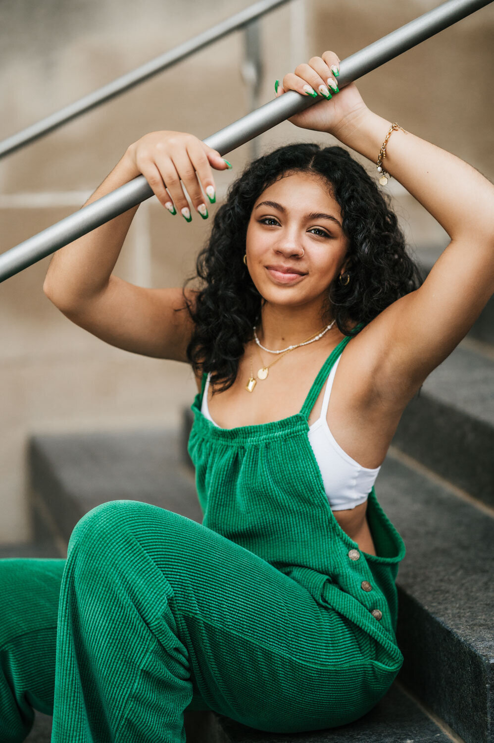 GIRL SITTING ON STEP HOLDING A BAR