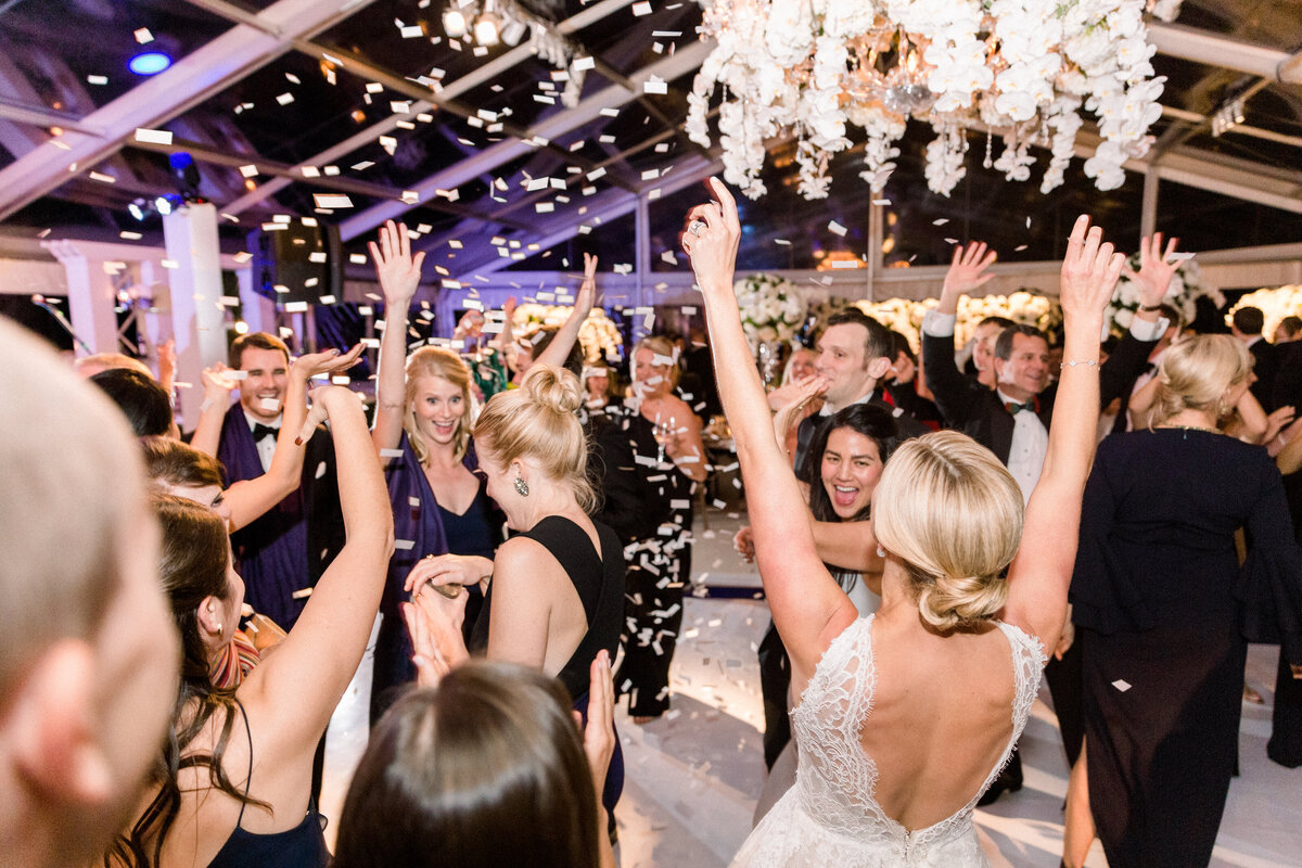 The wedding guests and the bride dancing. 