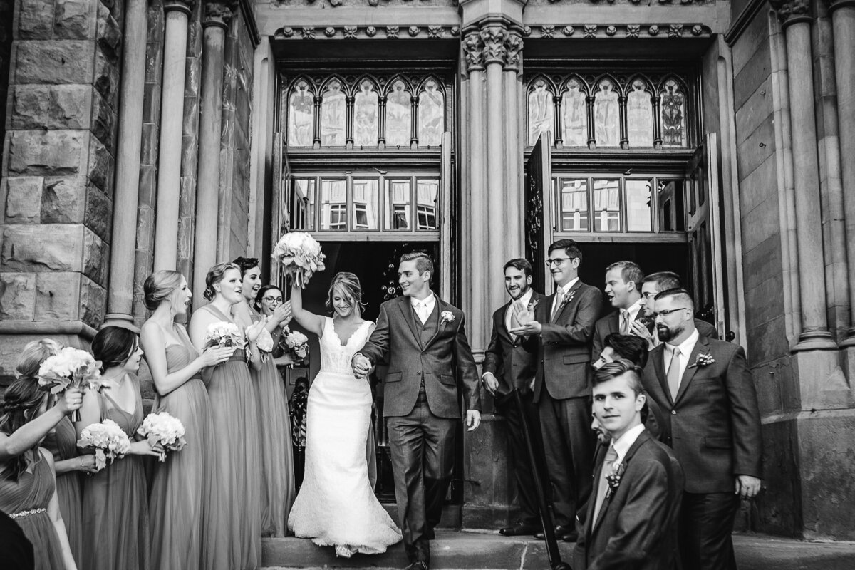 Bride and Groom leaving Church with guests surrounding them in Buffalo, New York