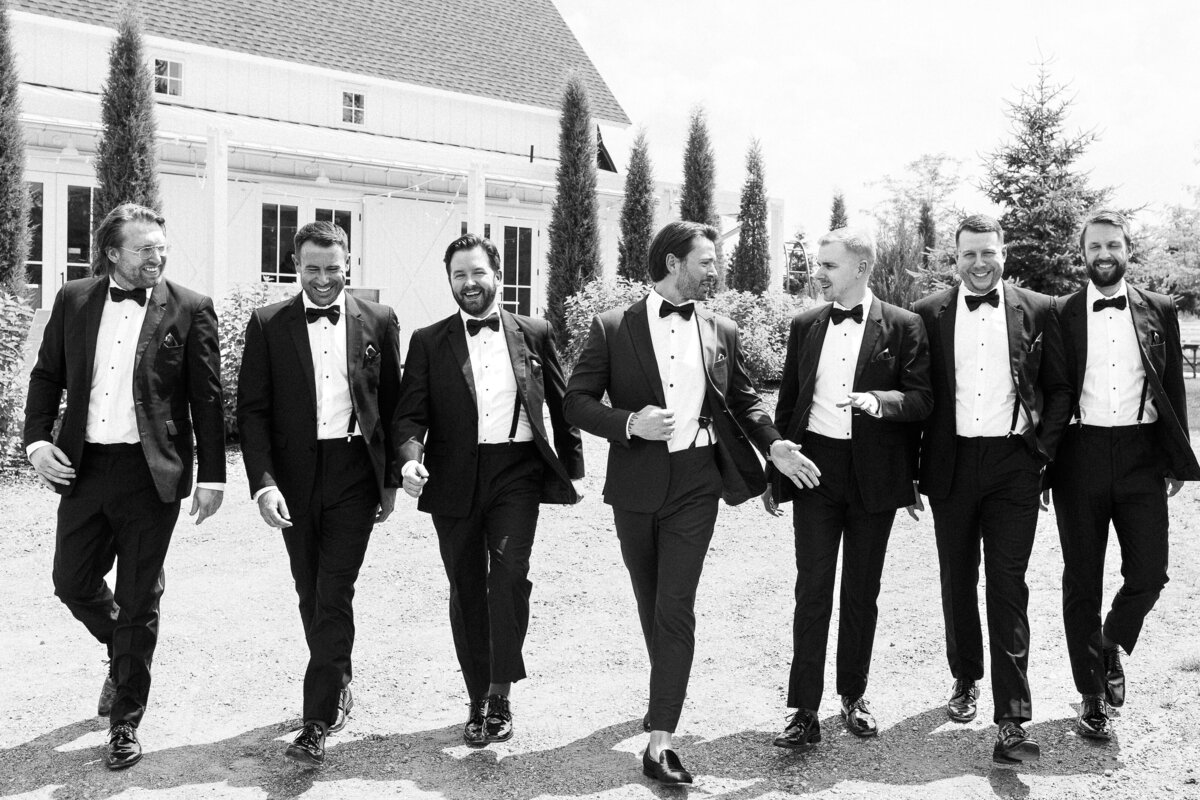 groomsmen in matching tuxedos