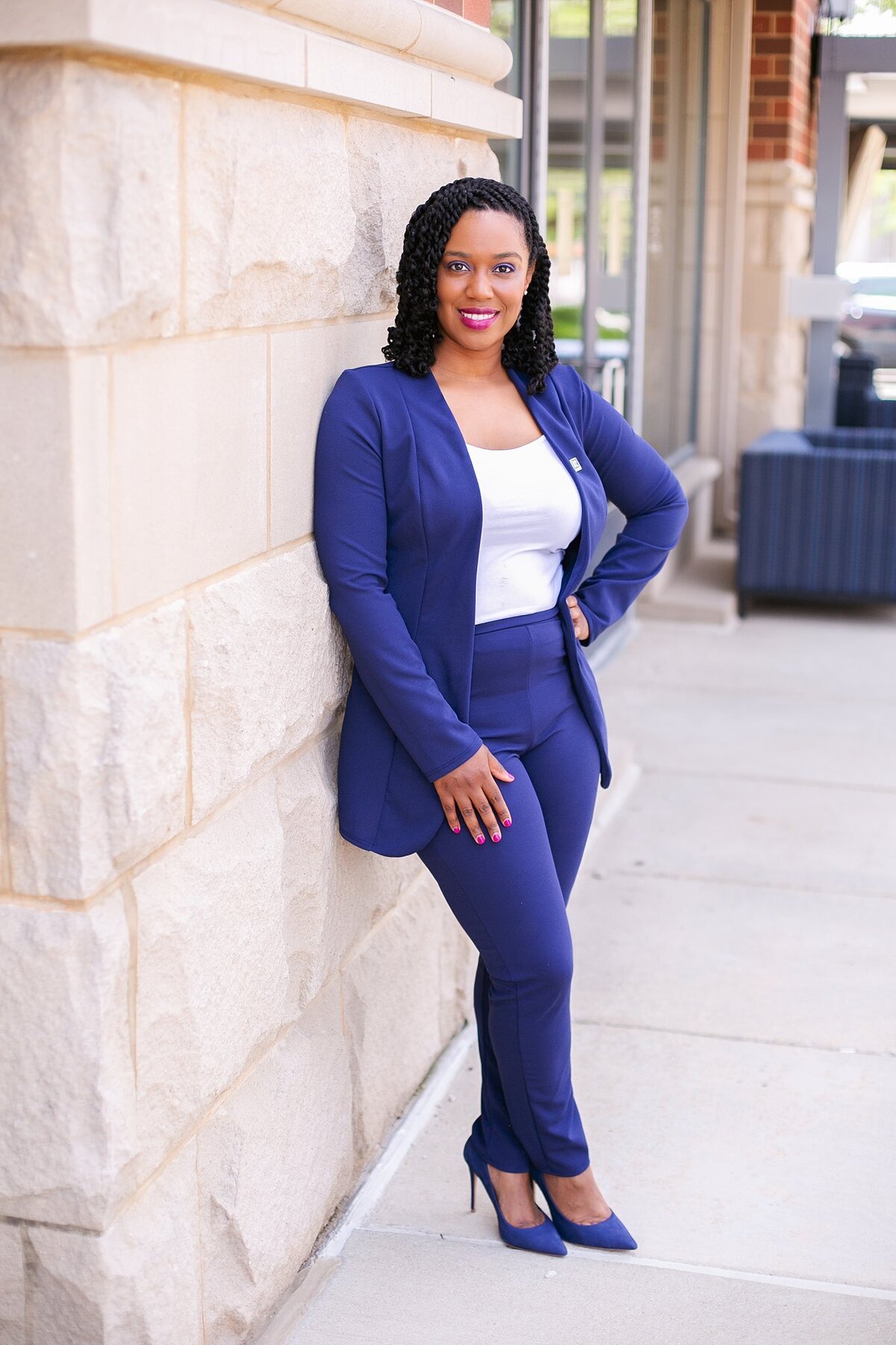 A-successful-businesswoman-in-a-navy-blazer-smiling-during-a-professional-headshot-session-in-Carmel-Indiana-for-real-estate-agents-and-entrepreneurs