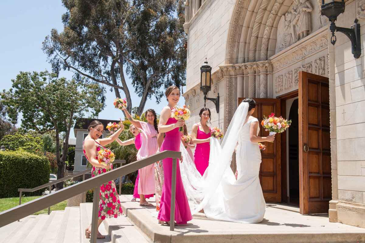 Bride and bridesmaids walking into St Monica's