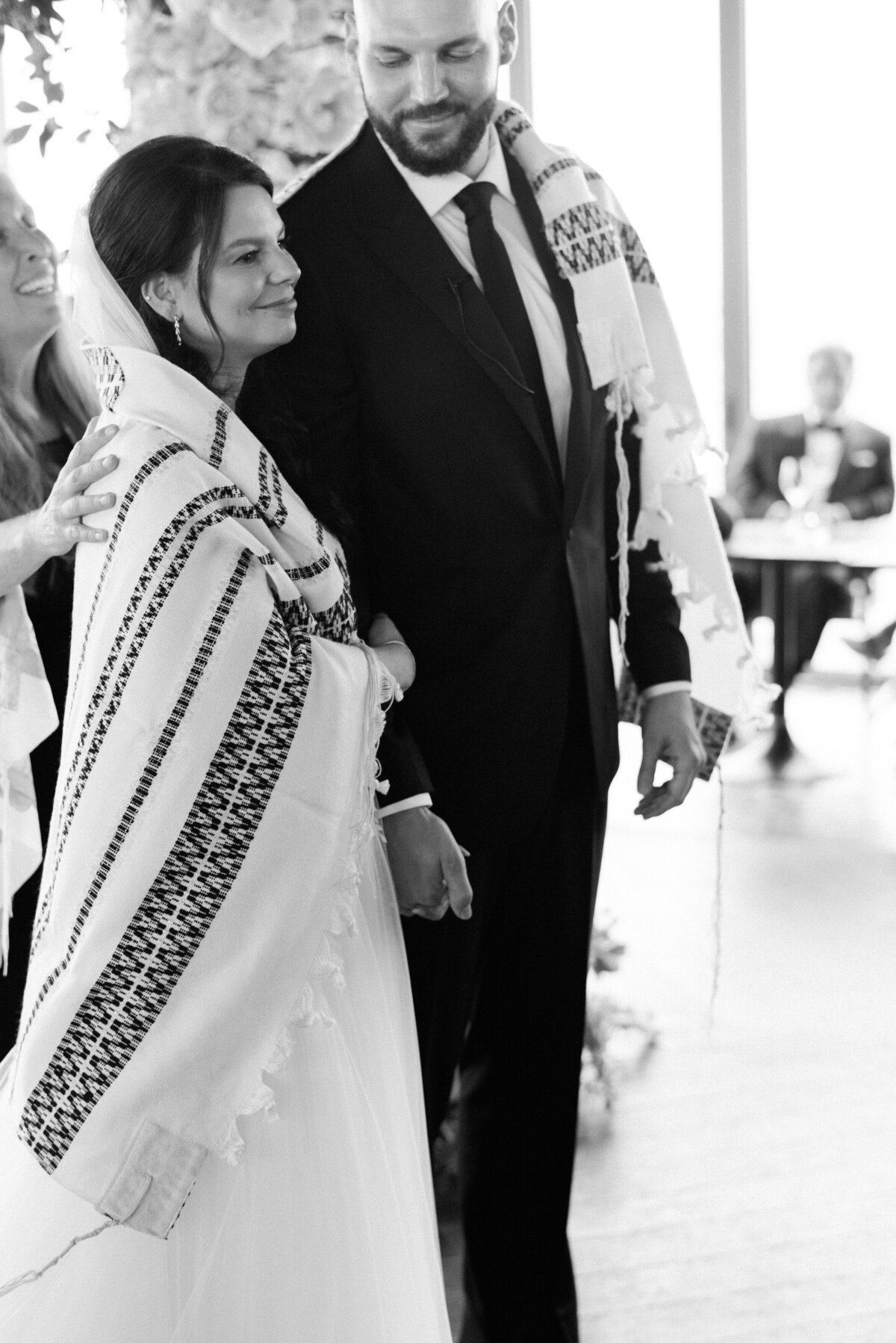 Bride wears a talit during Jewish ceremony 