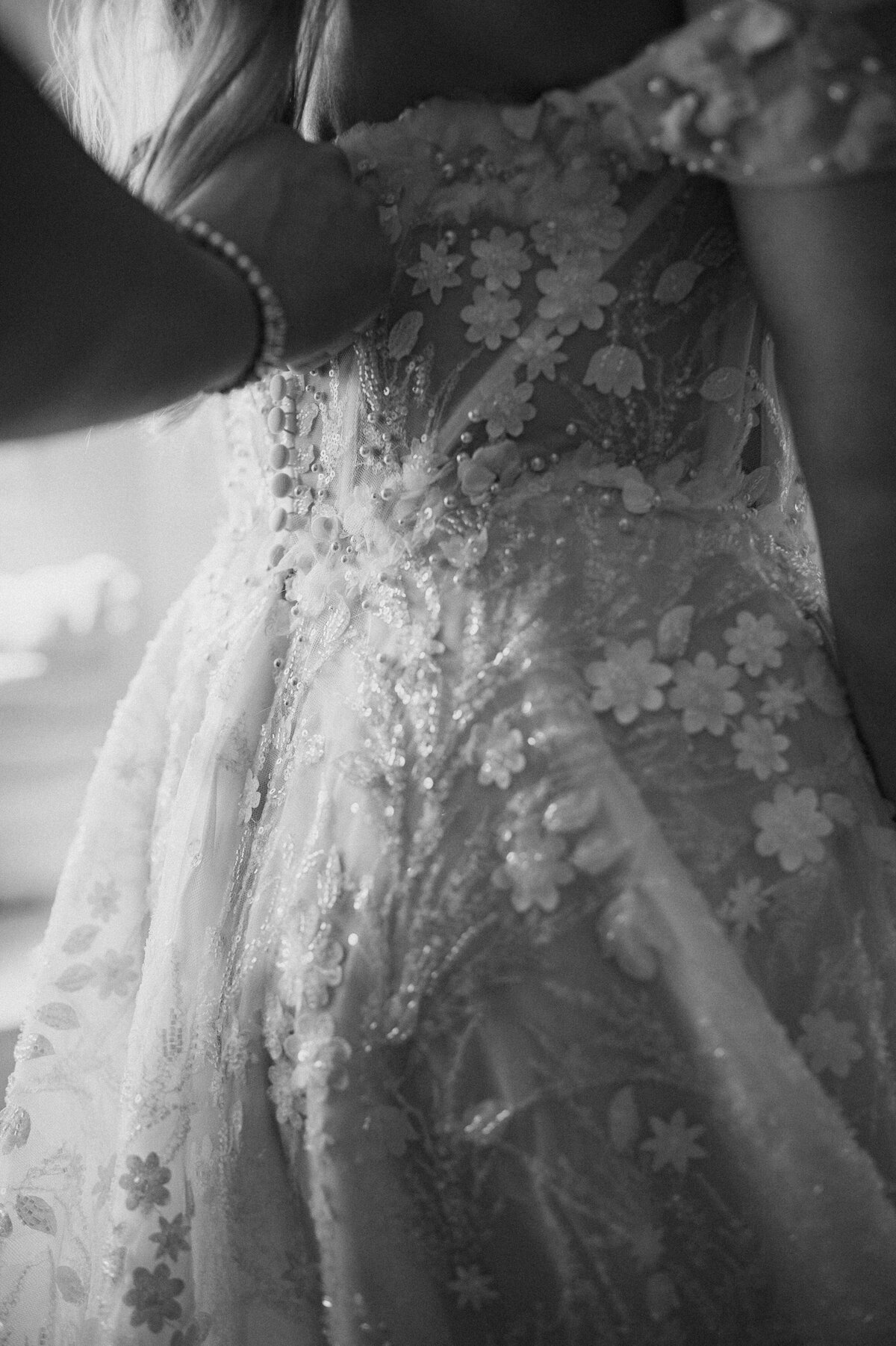 wedding dress being done up