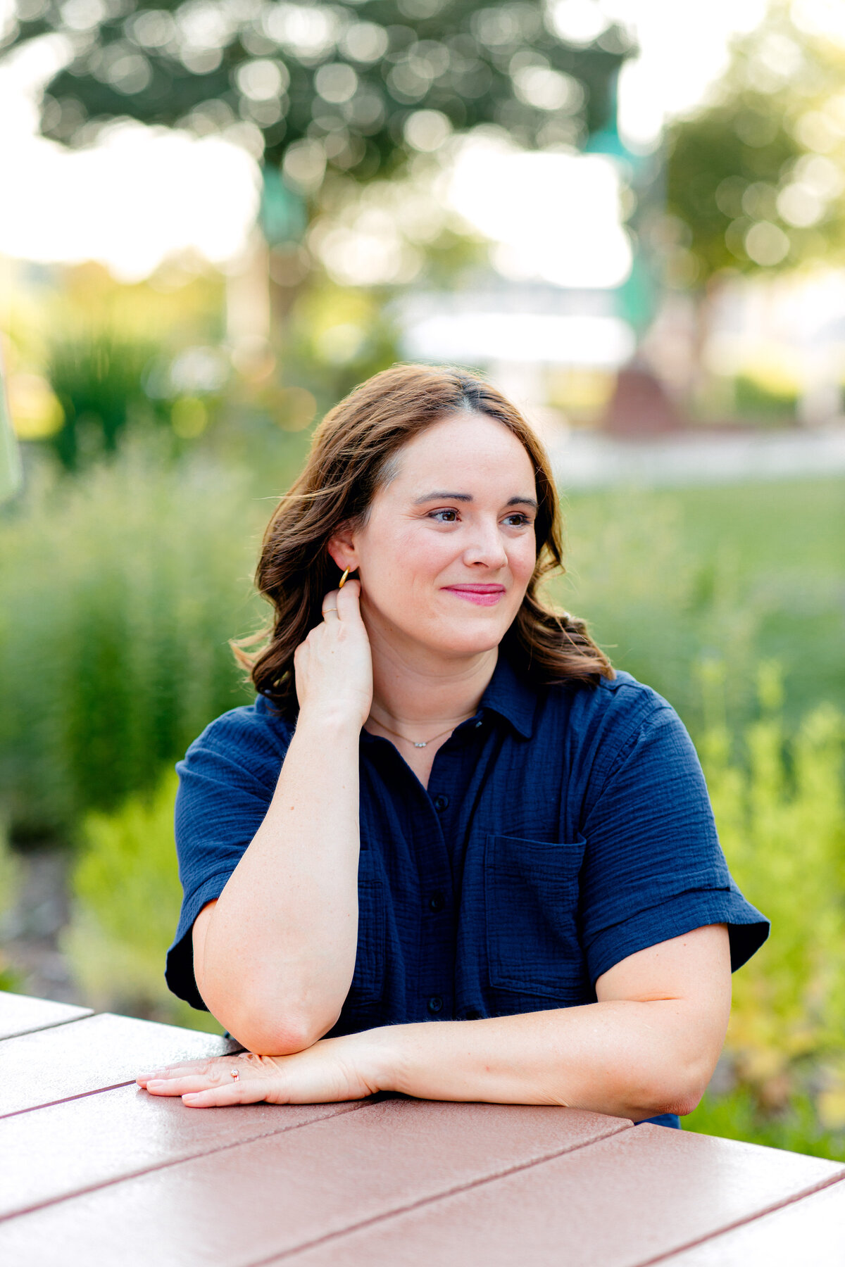 Woman smiling in blue outfit looking into the distance