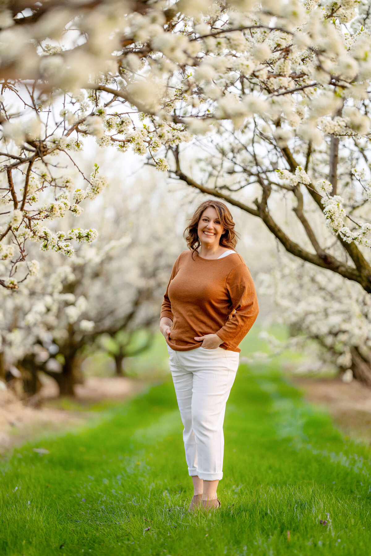 Amanda Gibson of Gibson Photography in the white cherry blossoms.  Burlington, Ontario photographer