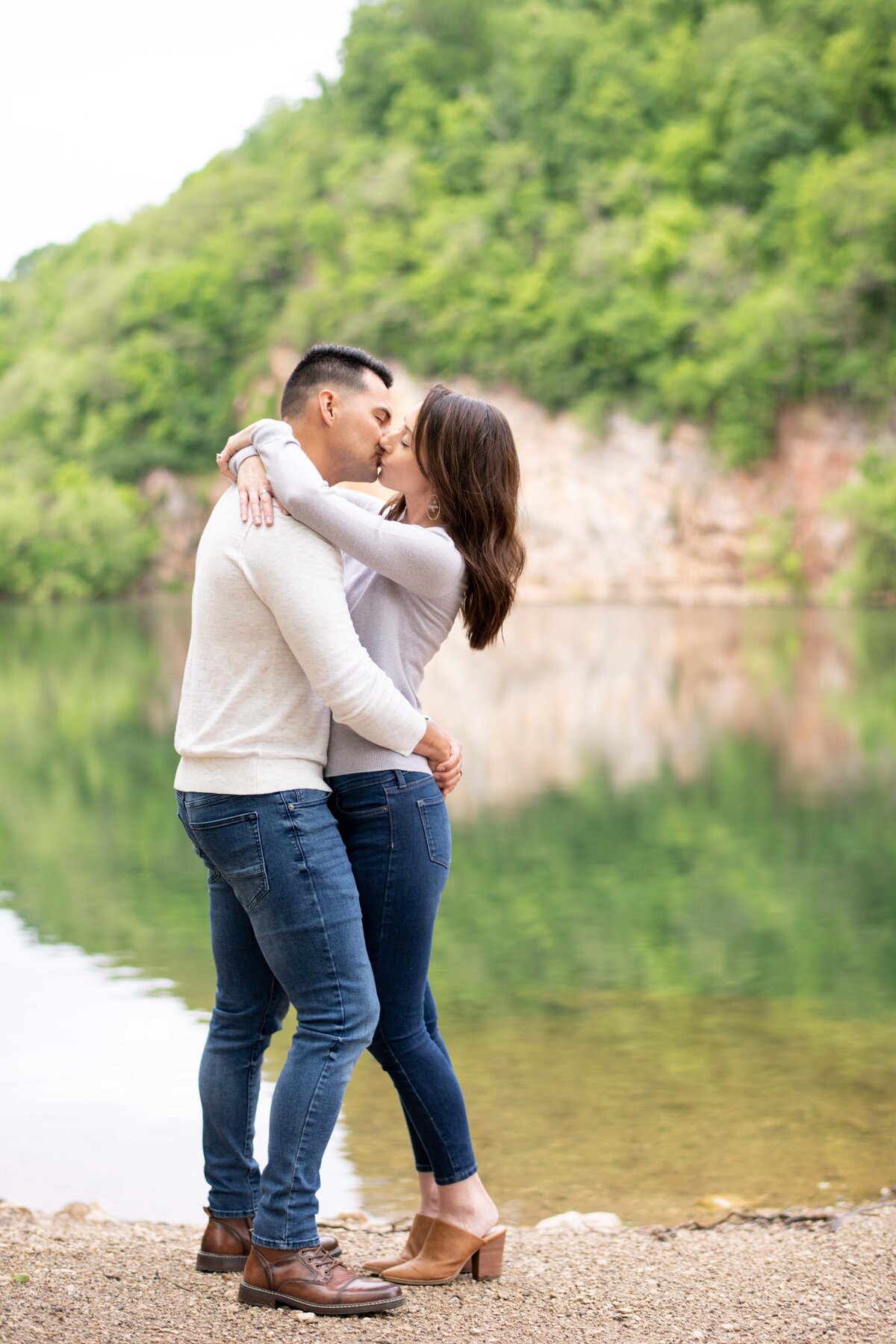 engaged couple in front of rock quarry lake