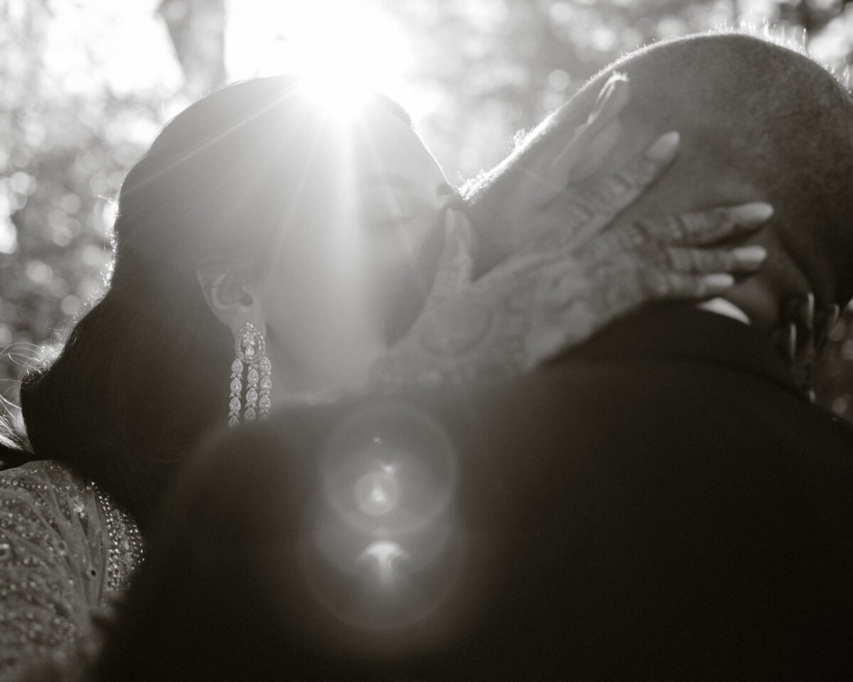 backlit kiss with newlyweds